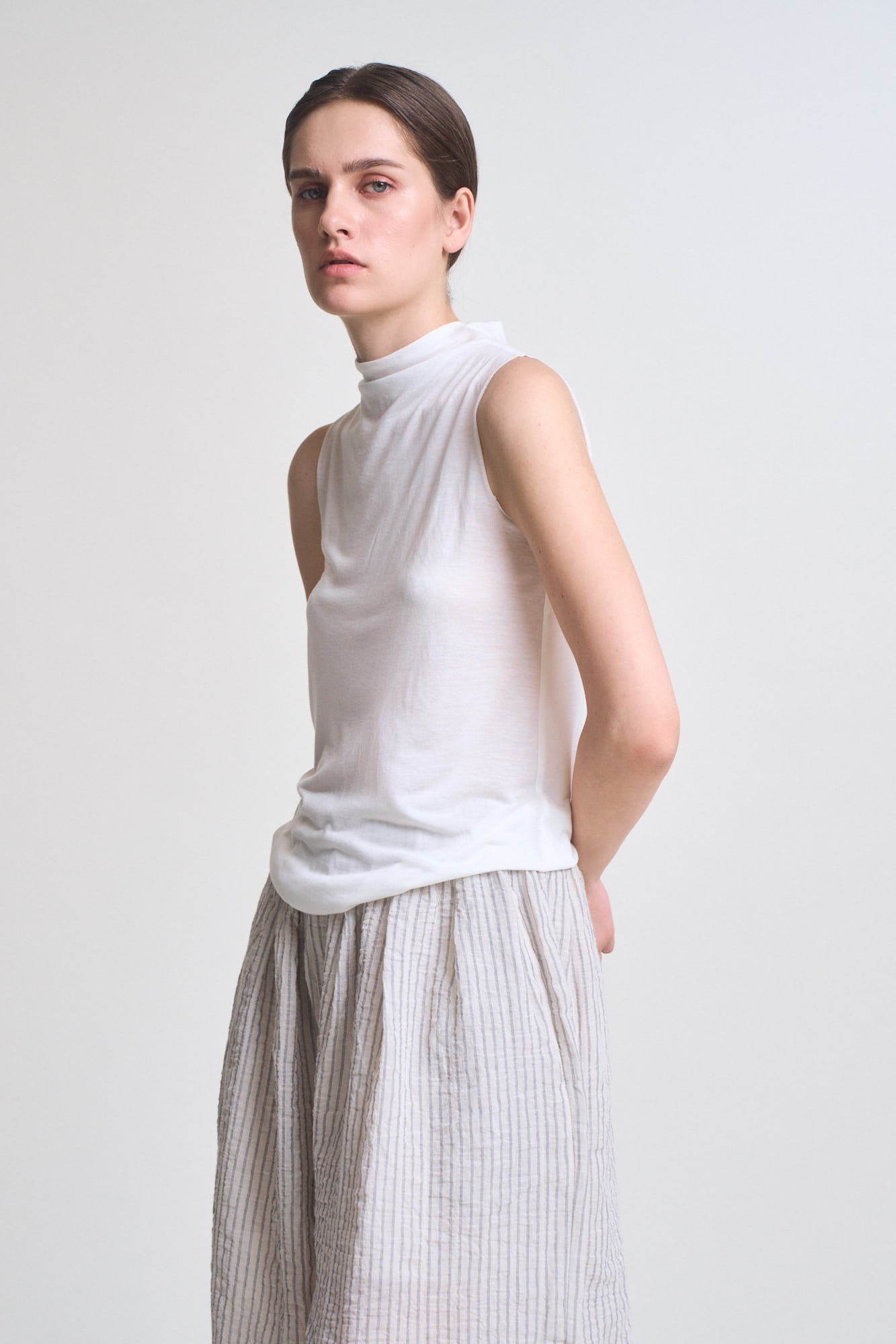 Cut And Sew Sleeveless Mock Neck Top in Off White
